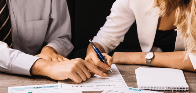 Couple Signing Loan Documents