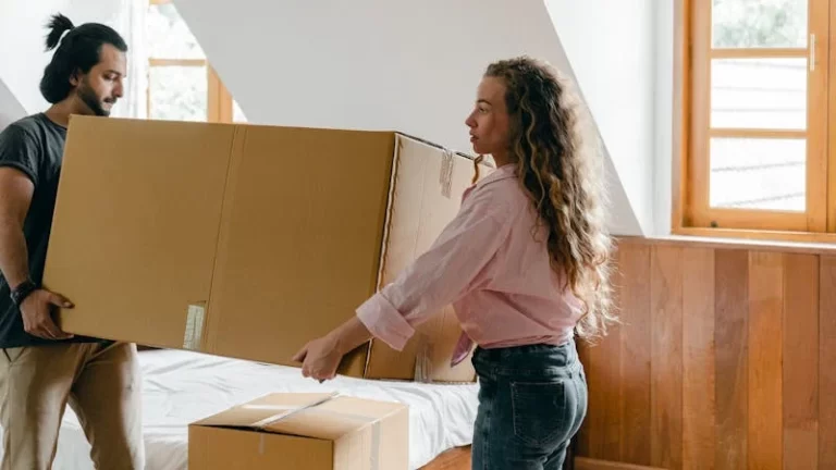 Two folks moving boxes.